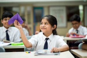 schoolgirl-throwing-paper-airpla