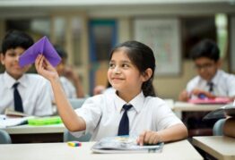 schoolgirl-throwing-paper-airpla